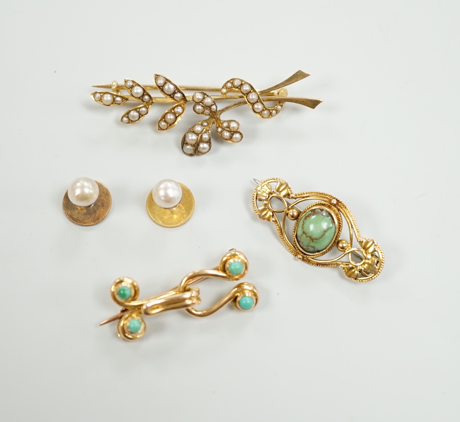 An Edwardian 15ct and seed pearl cluster set spray brooch, 47mm, a 15ct and four stone turquoise set brooch, one other yellow meta and turquoise brooch and a pair of 9ct and cultured pearl set dress studs.
